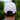 White Ball Cap at 6Whiskey six whisky Texas Standard. Men’s hats department-a close-up of a white cotton ball cap with a tan embroidered barbed wire logo on the front, curved brim, and structured crown, worn with a grey t-shirt against a green outdoor backdrop.