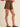 Outlaw Studded Skort at 6Whiskey, six whisky, gold stud detail, front pockets, elastic waistband, panel, soft, comfortable, edgy, western, versatile, closet staple, stand out piece, statement piece, all-year round, round top, rodeo, texas, girls night out, neutral, dark brown, espresso, suede, side view.