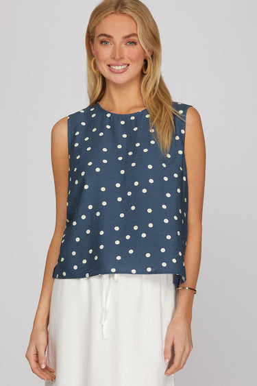 Dotted denim top at 6whiskey, six whisky, woman wearing blue and white polka dot top, ideal for fall game day or tailgate looks at texas a&m, aggies, SEC, gameday outift inspo, sleeveless top, polka dots, front view, football game outfit, watch party look, game day to everyday look. Pair with maroon or burgundy aggie accessories and sneakers, sandals, or booties. Texas A&M aggie style. Everyday casual chic aggie style. polka dot top for fall fashion. Matching set.