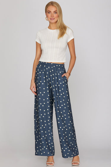 Dotted denim pants at 6whiskey, six whisky, woman wearing blue and white polka dot pants, ideal for fall game day or tailgate looks at texas a&m, aggies, SEC, gameday outift inspo, wide leg pants, polka dots, front view, football game outfit, watch party look, game day to everyday look. Pair with maroon or burgundy aggie accessories and sneakers, sandals, or booties. Texas A&M aggie style. Everyday casual chic aggie style. flowy pants for fall fashion. Pockets, stretchy waist band.