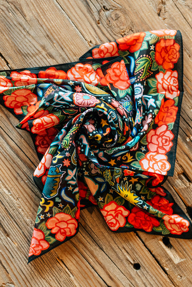 Rose Ranch Bandana by XOXO Art at 6Whiskey, six whisky, square, silk cotton bled, Mexican roses, western designs, hand drawn, sketch, modern, cool girl, edgy western, casual, stylish, colorful, pop of color, unique, black base, reds and pinks, front view.