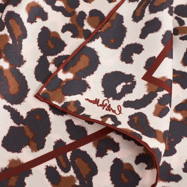 Spotted Chic Silk Bandana by Lost Pattern at 6Whiskey, six whisky, fall, winter, maroon, brown leopard on white background, statement accessory, bag accessory, hat accessory, edgy western, cool girl, it girl, leopard print, SEC sorority girl game day, rodeo, country music concert, girls night out, modern western, western accessory, detail corner view.