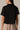 Black Half Zip Top by Pcil at 6Whiskey, six whisky, short sleeve, quarter zip neckline, gold zipper detail, soft, comfortable, cropped, relaxed, loungewear, errands, at home, matching set. Back view.