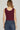 woman wearing a fitted sleeveless maroon knit tank paired with high-rise jeans – ideal for fall game day or tailgate looks at 6whiskey six whisky texas a&m aggies