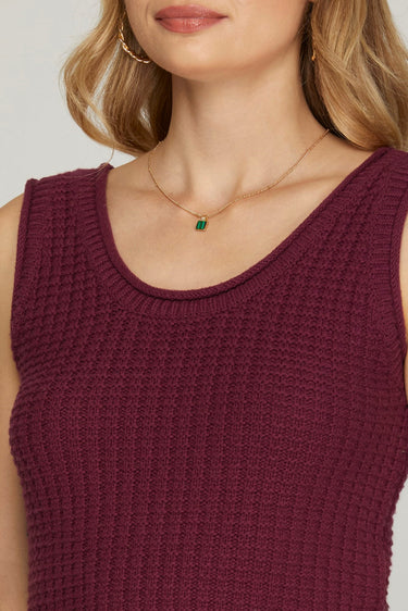 Close-up of a person women a maroon sleeveless top with a neutral background at 6whiskey six whisky texas a&m game day outfit