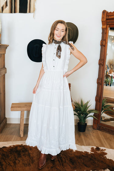 The Prairie Lace Dress by Tasha Polizzi at 6Whiskey, six whisky, Paris dress, white maxi dress, tiered, embroidery, delicate, elegant, feminine, western, chic, stylish, it girl, country concert, rodeo, church, lunch, two stepping, concho button, ruffle hemline, ruffle neckline, flowy, flattering. Front view.