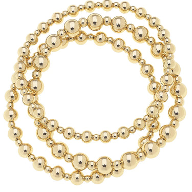 Gold Stretch Bracelets at 6Whiskey six whisky. Set of three gold-tone beaded stretch bracelets in varying bead sizes, coiled together on a white background.