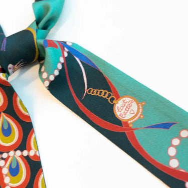 Peacock Silk Twilly at 6Whiskey, six whisky, green, blue, red, yellow, white, pearl, peacock design, flowing design, blues, greens, bold, vibrant, likely, personality, exciting, refined, eye-catching, colorful, pop of color, western accessory, rodeo, multicolor, handbag accessory, neck scarf, front view