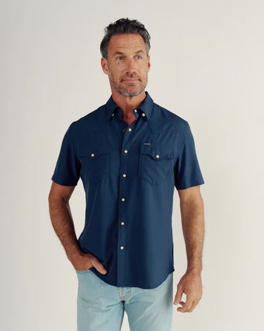 Short Sleeve Performance Pearl Snap in Navy by Tecovas at 6Whiskey, six whisky, collar, western yolk stitching, ventilation, UV proof, UPF protection, sweat proof, stretchy, moves with you, comfortable, spring, summer, short sleeves, keeps you cool, warm weather top, date night, rodeo, work, everyday, elevated western, stylish, modern western, refined, dark blue, sunglass pocket, front view.