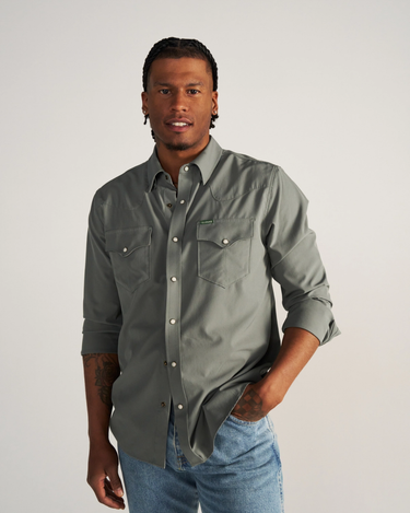 Long Sleeve Performance Pearl Snap in cactus green by Tecovas at 6Whiskey, six whisky, green pearl snaps, brass rings, stretch, comfortable, breathable, texas weather, SEC, southern charm, western stitching, front pockets, lightweight, men's must have, men's gift idea, rodeo, country concert, date night, work, elevated western, sweat proof, ventilated, collared, front view. hidden sunglass wipe, hidden sunglass pocket. sleeve rolled up or down
