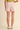 Rosebud Stitched Shorts at 6Whiskey, six whisky, baby pink, light pink, dusty pink, tailored look, pleated, tortoise shell buttons, belt loops, side pockets, faux back pockets, diamond embroidery white hem stitching, high waisted, flattering, feminine, southern charm, southern belle, girly, lined, modest length, summer and spring style, lunch, church, errands, market, casual chic, effortless cool, it girl, polished, put together, refined, back view