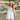 Down south twilly at 6whiskey, six whisky, Texas A&M maroon burgundy western icon graphic, maroon and white, soft, lightweight, breathable, comfortable, accessory, scarf, twilly, ribbon, gameday, tailgating, football, SEC, western, casual. Front view. Woman wearing white dress holding twilly. Tie on neck, wrist, beltloops, or on purse. Aggie style and gameday outfit inspo. Horseshoe, boots, bucking horse and cowboy.