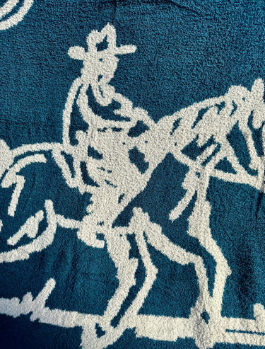 Lone Rider Blanket in teal at 6Whiskey, six whisky, blue, soft blanket, cozy, warm, comfortable, bed, couch, patio, bench, gift idea, western home decor, unique throw blanket, square blanket, large, handrawn design, country, ranch, detail view.