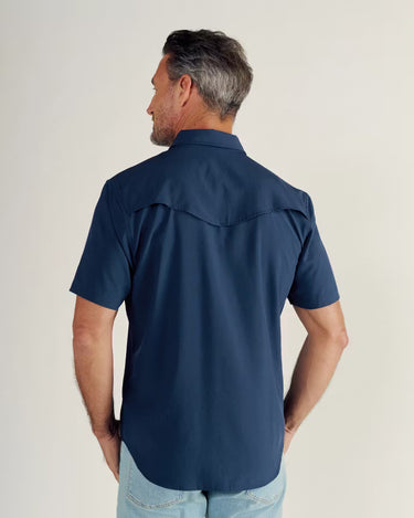 Short Sleeve Performance Pearl Snap in Navy by Tecovas at 6Whiskey, six whisky, collar, western yolk stitching, ventilation, UV proof, UPF protection, sweat proof, stretchy, moves with you, comfortable, spring, summer, short sleeves, keeps you cool, warm weather top, date night, rodeo, work, everyday, elevated western, stylish, modern western, refined, dark blue, sunglass pocket, back view.