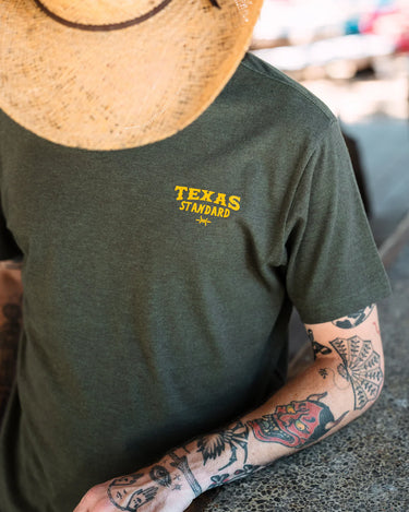 Texas Standard Jackalope tee at 6Whiskey six whisky lightweight and breathable. Texas Standard short sleeve cool wrinkle-resistant. Heathered green legend of the west tee. Frontview TX Standard logo on chest. 