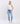 6Whiskey women's pants Hailey High-Rise Distressed Straight Jeans in light blue wash with ripped knee details and raw hem, paired with white sneakers