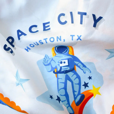 Space City Silk Scarf, cowboy, rocket, spaceship, texas graphic, oil rig, texas flag, cowboy boot, bluebonnets, Houston, TX, texas pride, lone star style, white background, asymmetrical design, unique, statement piece, graphic design. Detail view. 