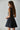 The Essential Black Dress at 6Whiskey, six whisky, flare skirt, pleated, flowy, structured top, sleeveless, little black dress, mini dress, gameday, aggies, texas a&m, tailgate outfit, SEC gameday. Side view.