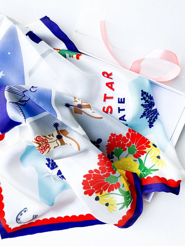 Lone Star State Silk Scarf, bandana, square, soft, smooth, texas icon graphics, texas pride, lone star, blue bonnet, cowboy boot, texas outline, texas flag, cactus, horseshoe, asymmetrical, stars, scallop boarder, red, white, blue, yellow, brown, green. Detail view. 