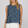 Dotted denim top at 6whiskey, six whisky, woman wearing blue and white polka dot top, ideal for fall game day or tailgate looks at texas a&m, aggies, SEC, gameday outift inspo, sleeveless top, polka dots, front view, football game outfit, watch party look, game day to everyday look. Pair with maroon or burgundy aggie accessories and sneakers, sandals, or booties. Texas A&M aggie style. Everyday casual chic aggie style. polka dot top for fall fashion. Matching set.
