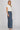 Dotted denim pants at 6whiskey, six whisky, woman wearing blue and white polka dot pants, ideal for fall game day or tailgate looks at texas a&m, aggies, SEC, gameday outift inspo, wide leg pants, polka dots, front side view, football game outfit, watch party look, game day to everyday look. Pair with maroon or burgundy aggie accessories and sneakers, sandals, or booties. Texas A&M aggie style. Everyday casual chic aggie style. flowy pants for fall fashion. Pockets, stretchy waist band.
