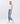 6Whiskey women's pants Hailey High-Rise Distressed Straight Jeans in light blue wash with ripped knee details and raw hem, paired with white sneakers