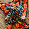 Rose Ranch Bandana by XOXO Art at 6Whiskey, six whisky, square, silk cotton bled, Mexican roses, western designs, hand drawn, sketch, modern, cool girl, edgy western, casual, stylish, colorful, pop of color, unique, black base, reds and pinks, front view. 
