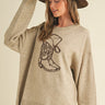 Rodeo Knit Pullover at 6Whiskey, six whiskey, round neckline, crewneck, ribbed hemline, oversized, neutral beige, dark brown, boot graphic, country, western, casual, rodeo, country, country concert, lunch date, market, errands, layer, fall, winter, cooler weather, front view.