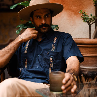 Men's navy linen tejas guayabera shirt by Texas Standard featuring traditional four-pocket design and gold embroidered detailing, available at 6Whiskey six whisky– modern western menswear from Austin, Texas, bryan, texas, lone star lifestyle