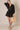Black Linen Romper at 6Whiskey, six whisky, women's fashion, front tie detail, front wrap, collared neck, elastic wrist cuff, casual, relaxed, chic, effortless, stylish, fall. Front view.