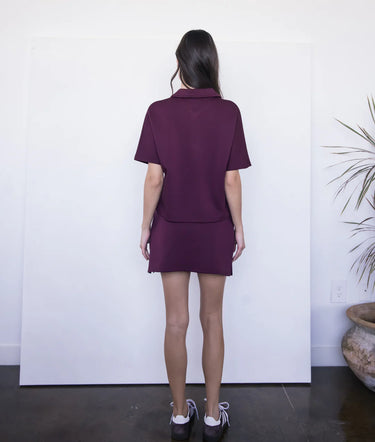 Burgundy Skort at 6Whiskey, six whisky, lined, breathable, stretchable, side slit, maroon, flattering, matching set, casual chic, casual wear, aggies, tamu, gameday, texas a&m, leisure, elevated leisure, back view.