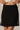Piping Black Mini Skirt by P.cill at 6Whiskey, six whiskey, white side piping, high elastic waistband, comfy, cozy, sporty, elevated, classy, chic, sleek, matching set, pickleball, errands, loungewear. Front view.