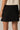 Piping Black Mini Skirt by P.cill at 6Whiskey, six whiskey, white side piping, high elastic waistband, comfy, cozy, sporty, elevated, classy, chic, sleek, matching set, pickleball, errands, loungewear. Back view.