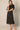 Black Linen Cargo Skirt by Pcill at 6Whiskey, six whiskey, pockets, back elastic waistband, cool girl, elegant western, casual, breathable, tailored, concert, dinner date, night out, matching set. Front view.