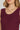 Close-up of a person women a maroon sleeveless top with a neutral background at 6whiskey six whisky texas a&m game day outfit