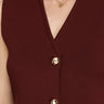 Close-up of a burgundy sleeveless top with gold buttons and a necklace.