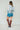 Old Town Graphic Button Down by Tasha Polizzi at 6Whiskey six whisky, featuring colorful western illustrations like cowboy boots, “Howdy” text, and cacti, styled with high-rise distressed denim shorts old gringo red mayra tall boots