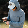 Man wearing Texas Standard Brazos Hoodie in Bayou Blue while fly fishing, showcasing UPF 50+ sun protection, moisture-wicking performance, and breathable stretch fabric – available at 6Whiskey, Texas lifestyle clothing store