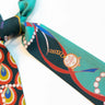 Peacock Silk Twilly at 6Whiskey, six whisky, green, blue, red, yellow, white, pearl, peacock design, flowing design, blues, greens, bold, vibrant, likely, personality, exciting, refined, eye-catching, colorful, pop of color, western accessory, rodeo, multicolor, handbag accessory, neck scarf, front view