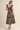 Midnight Garden Dress at 6Whiskey six whisky, panel, geometric, floral, patterned, purple, navy, yellow, orange, green, split neckline, v-neck, sleeveless, ruffle sleeve, ruffle hem, smocked back, feminine fit, flattering, romantic, dramatic, bold, eye-catching, edgy western, cool girl, eclectic, elevated, women's dress, midi dress, women's clothing, fashion, back view