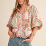 Maribel Mosaic Blouse at 6Whiskey, six whisky, split neckline, v-neckline, tie tassel front, 1/2 sleeve, flutter sleeve, puff sleeve, short sleeve, floral patterned, panel, geometric, multicolor, green, pink, orange, cream, lightweight, flowy, relaxed, spring and summer, lunch, brunch, church, work to weekend, feminine, front view