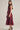 Aggie darling dress at 6Whiskey, six whisky, midi dress, adjustable belt, v-neck, sleeveless dress, casual dress, western, contrast piping detail, collar, game day, tailgating, texas a&m, SEC, side profile, side view, full view, full length, maroon dress, burgundy dress, gameday outfit, button up front dress, casual chic aggie dress, aggies, a&m outfit, belted waist dress.