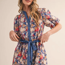 Floral Pop Romper at 6Whiskey, six whisky, short sleeves, puff sleeves, adjustable waistband, comfortable, casual, casual western, vintage floral, whimsical floral, contrast front placket, button down detail, split neck, v-neck, lightweight, breathable, navy blue, pink yellow, white, red, orange, spring summer, front view