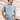 Men's blue linen tejas guayabera shirt by Texas Standard featuring traditional four-pocket design and white embroidered detailing, available at 6Whiskey six whisky– modern western menswear from Austin, Texas, bryan, texas, lone star lifestyle Men's casual summer stlye. Front view lifestyle