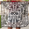 Senorita black and white bandana by Fringe Scarves at 6Whiskey, six whisky, floral theme, white, black, pair with burgundy or maroon, square, soft, comfortable, breathable, year-round, must-have, eye-catching, classic western, timeless, elevated, front view. Scarf with floral & geometric design held by a person in a rustic setting. Texas A&M gameday, game day, A&M, Aggie style, western aggie style for gamedays, football gameday style SEC, wear to Kyle field or tailgates.