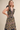 Midnight Garden Dress at 6Whiskey six whisky, panel, geometric, floral, patterned, purple, navy, yellow, orange, green, split neckline, v-neck, sleeveless, ruffle sleeve, ruffle hem, smocked back, feminine fit, flattering, romantic, dramatic, bold, eye-catching, edgy western, cool girl, eclectic, elevated, women's dress, midi dress, women's clothing, fashion, front view