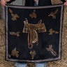 Take a seat silk scarf by Fringe Scarves at 6Whiskey, six whisky, equestrian theme, saddle, horse saddles, white, black, brown, burgundy, maroon, square, soft, comfortable, breathable, year-round, must-have, eye-catching, classic western, timeless, elevated, front view. Scarf with equestrian-themed design held by a person in a rustic setting. Texas A&M gameday, game day, A&M, Aggie style, western aggie style for gamedays, football gameday style SEC, wear to Kyle field or tailgates.