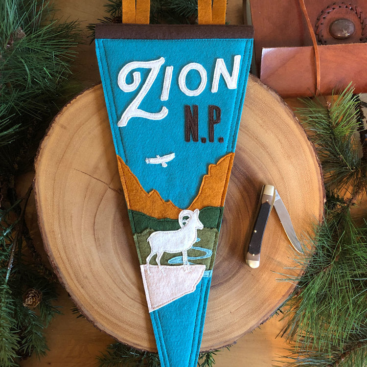 Load image into Gallery viewer, Zion National Park Handmade Felt Pennant at 6Whiskey six whisky featuring bright blue sky with ram and moutians
